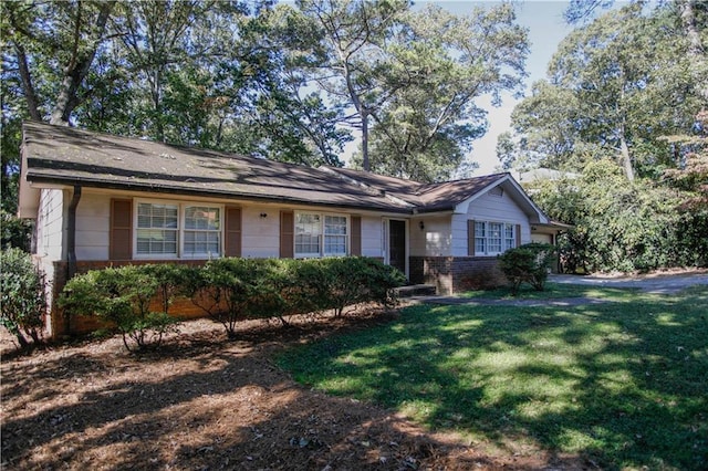 ranch-style home featuring a front yard