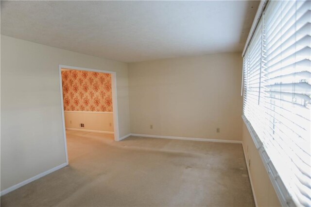 unfurnished room with light colored carpet