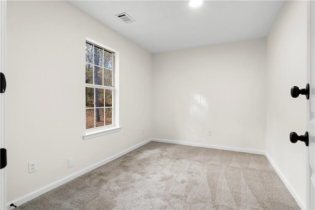 unfurnished room featuring baseboards, carpet flooring, and visible vents