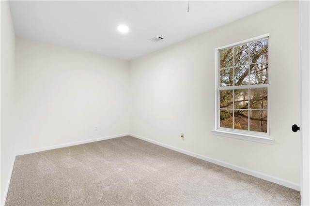 carpeted empty room featuring visible vents, recessed lighting, and baseboards