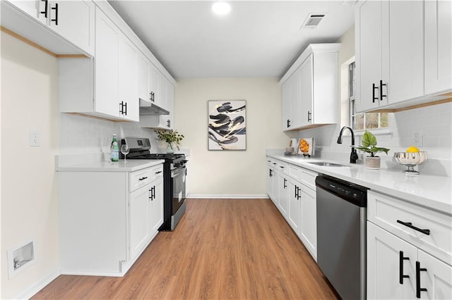 kitchen featuring a sink, gas range, tasteful backsplash, stainless steel dishwasher, and visible vents