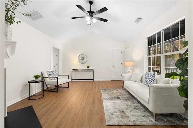 living area featuring visible vents, a ceiling fan, lofted ceiling, and wood finished floors