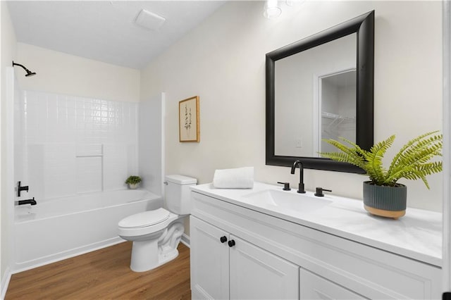 full bathroom featuring vanity, shower / bathtub combination, toilet, and wood finished floors