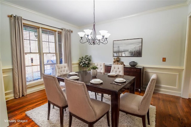 dining room with dark hardwood / wood-style flooring, crown molding, and a chandelier