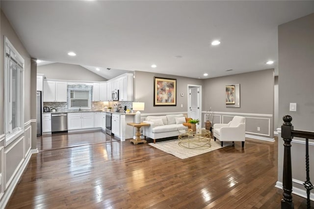 1684 Braeburn Dr SE, Atlanta, GA 30316 - living room featuring lofted ceiling, dark wood-type flooring, and recessed lighting