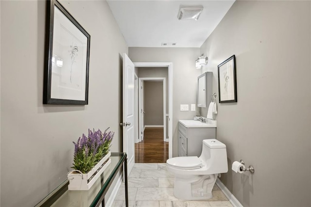 1684 Braeburn Dr SE, Atlanta, GA 30316 - bathroom featuring marble finish flooring, vanity, toilet, and baseboards