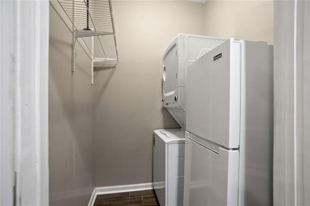 1684 Braeburn Dr SE, Atlanta, GA 30316 - washroom featuring stacked washer / drying machine, baseboards, and dark wood-style floors