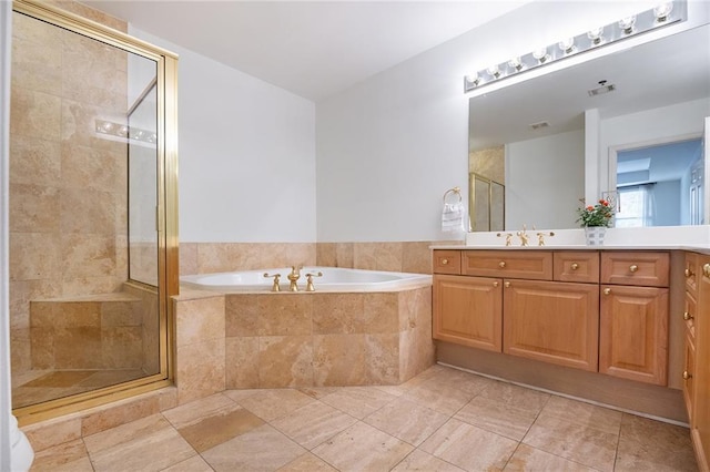 bathroom with a stall shower, visible vents, a garden tub, and vanity