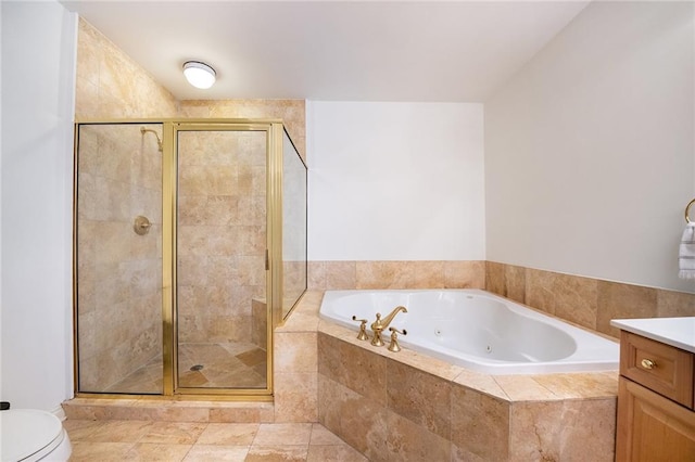 full bathroom featuring toilet, a stall shower, a tub with jets, and vanity