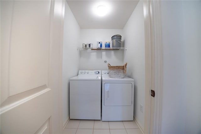 clothes washing area featuring laundry area, light tile patterned floors, and independent washer and dryer