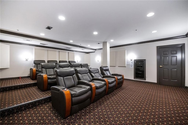 cinema room with visible vents, baseboards, ornamental molding, dark colored carpet, and recessed lighting