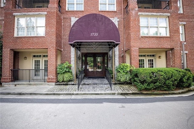 1735 Peachtree St NE Unit 321, Atlanta, GA 30309 - doorway to property featuring french doors and brick siding