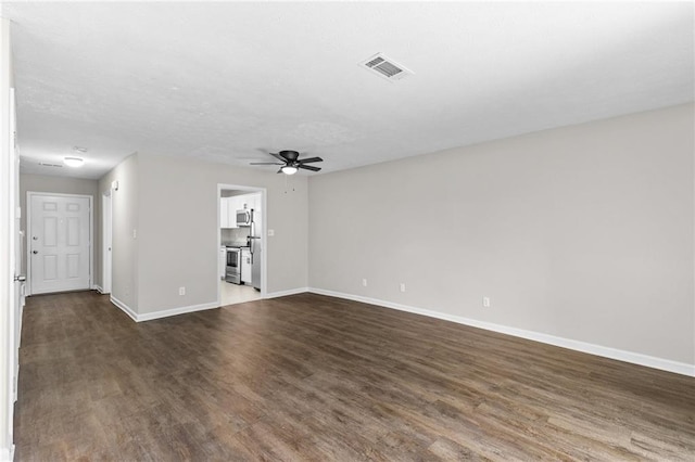 unfurnished living room with visible vents, baseboards, dark wood-type flooring, and a ceiling fan