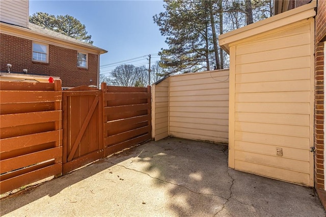 view of gate with a patio area and fence