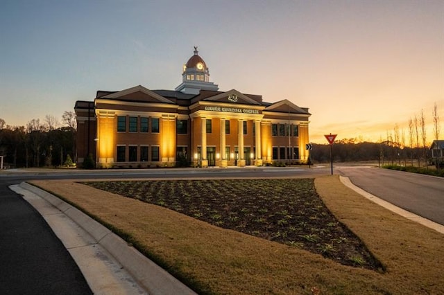 view of outdoor building at dusk