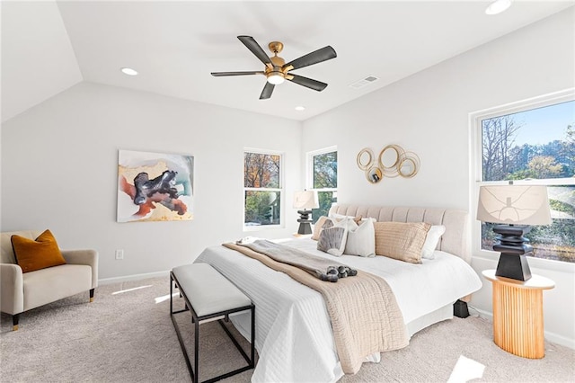 carpeted bedroom featuring multiple windows, ceiling fan, and vaulted ceiling