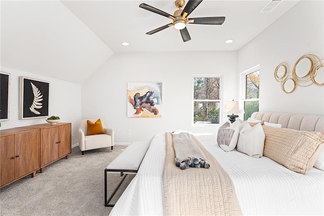 bedroom with ceiling fan, light colored carpet, and vaulted ceiling