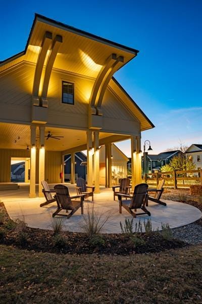 back house at dusk with a patio area