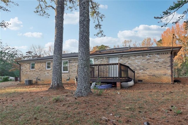 rear view of property featuring a deck and central air condition unit