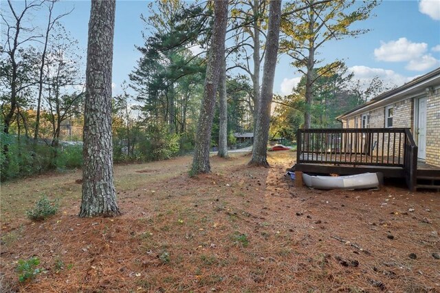 view of yard with a wooden deck