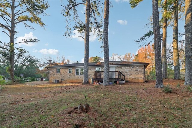 rear view of property with a wooden deck