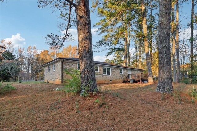 rear view of house featuring a deck