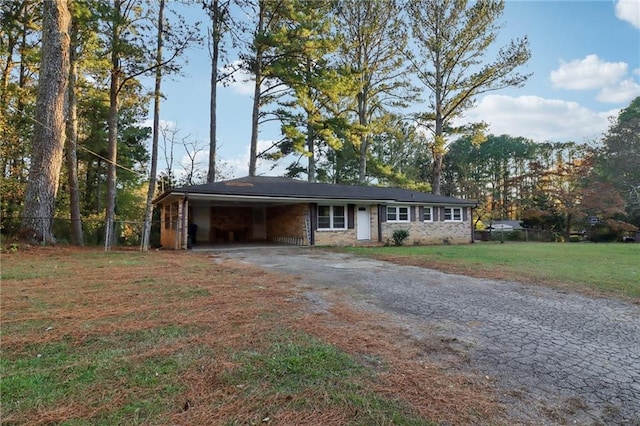 single story home with a front lawn and a carport