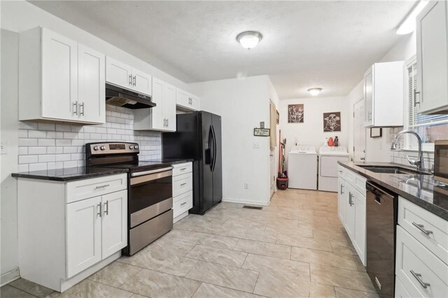 kitchen with sink, washer and dryer, black appliances, dark stone countertops, and white cabinetry