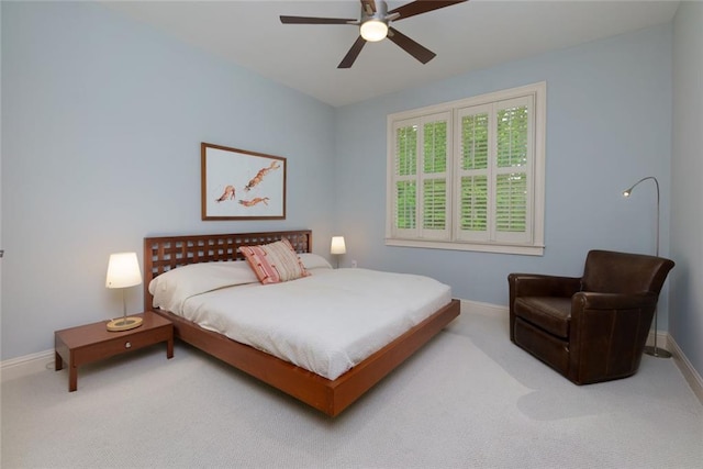 carpeted bedroom featuring baseboards and ceiling fan