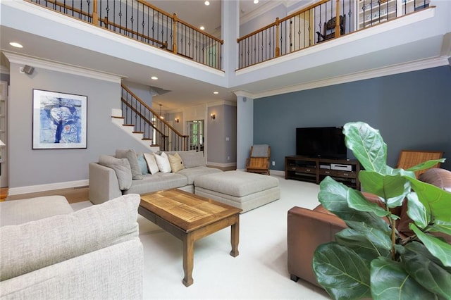 living room with a towering ceiling, stairs, baseboards, ornamental molding, and recessed lighting