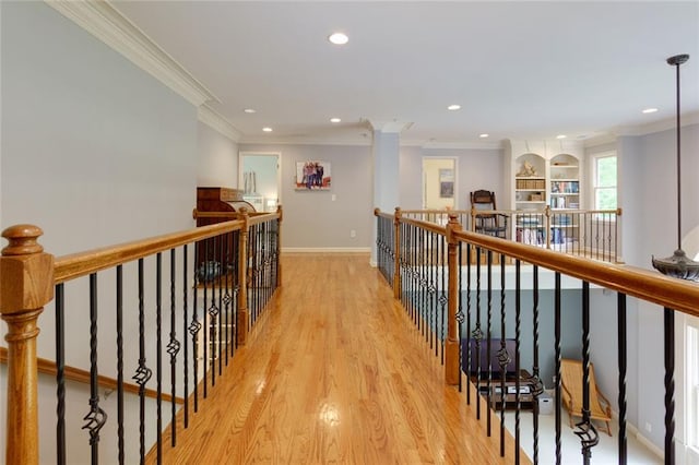 corridor with recessed lighting, an upstairs landing, ornamental molding, and light wood finished floors