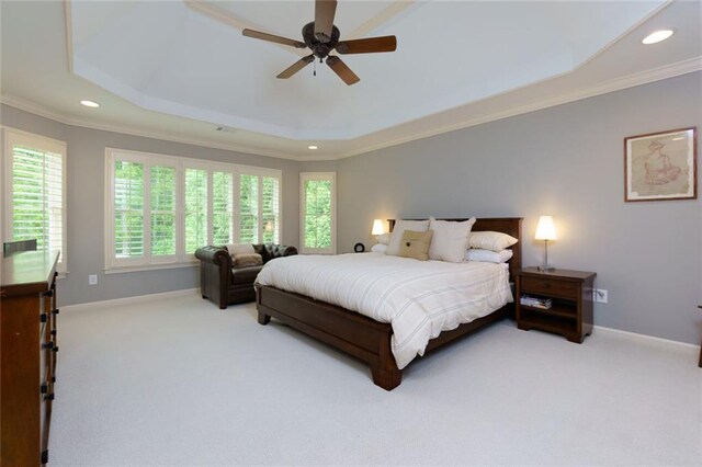 bedroom with crown molding, carpet, and a raised ceiling