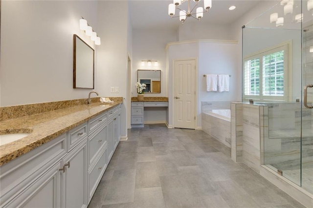 bathroom featuring a garden tub, double vanity, a stall shower, and a notable chandelier