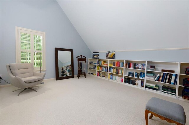 sitting room featuring carpet flooring and lofted ceiling