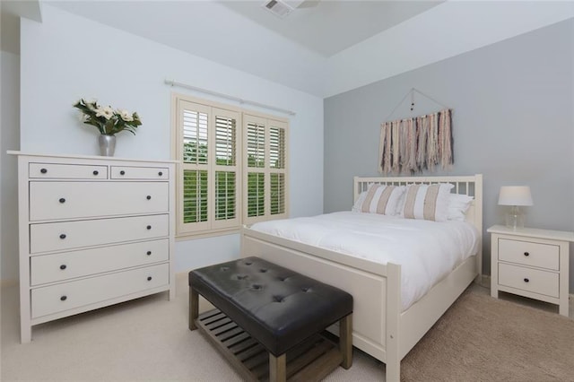 bedroom with visible vents and light carpet