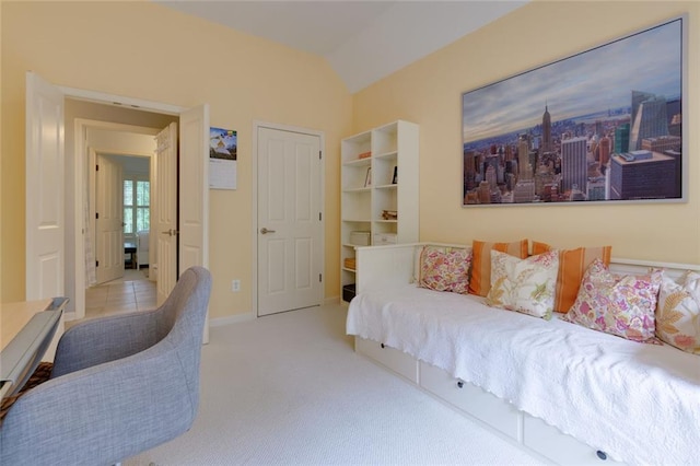 carpeted bedroom with baseboards and lofted ceiling