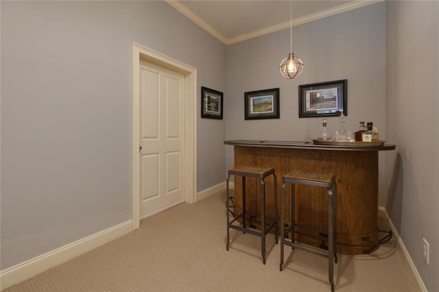 bar featuring light colored carpet, a dry bar, baseboards, and ornamental molding