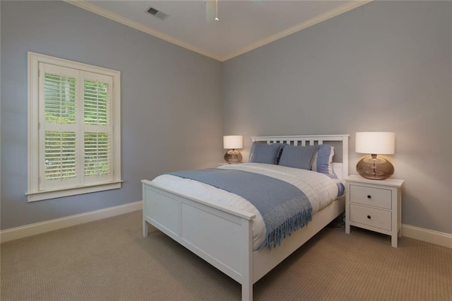 carpeted bedroom featuring crown molding, baseboards, a ceiling fan, and visible vents
