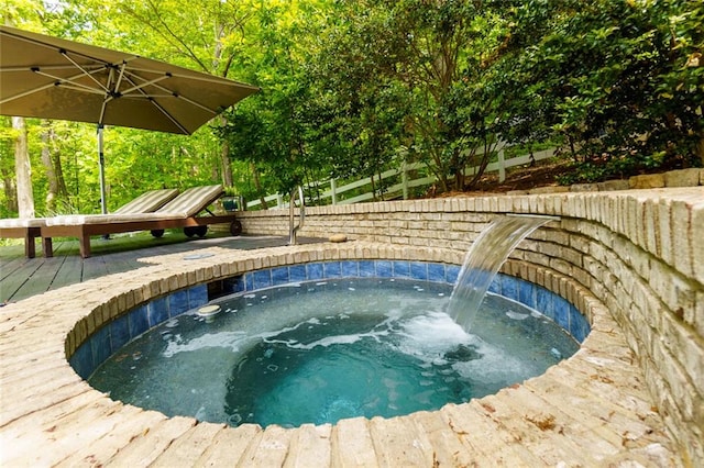 view of swimming pool featuring an outdoor hot tub and a deck