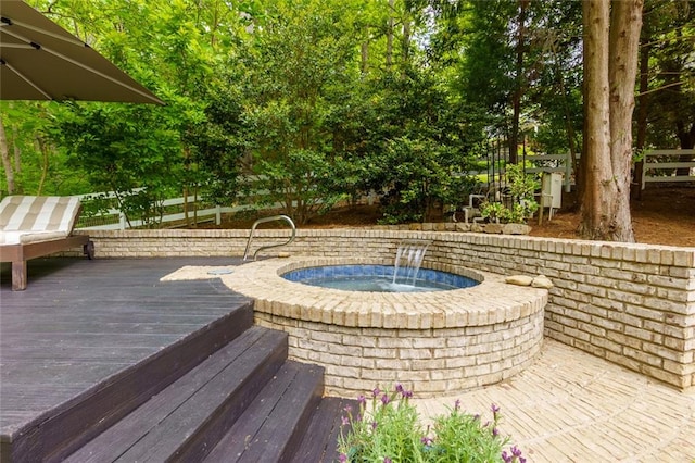 exterior space featuring an outdoor hot tub and fence