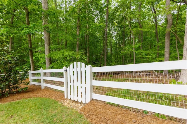 view of gate with fence
