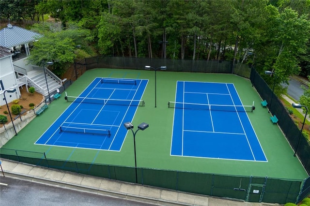 view of tennis court featuring fence
