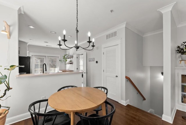 dining area featuring baseboards, crown molding, visible vents, and dark wood-style flooring