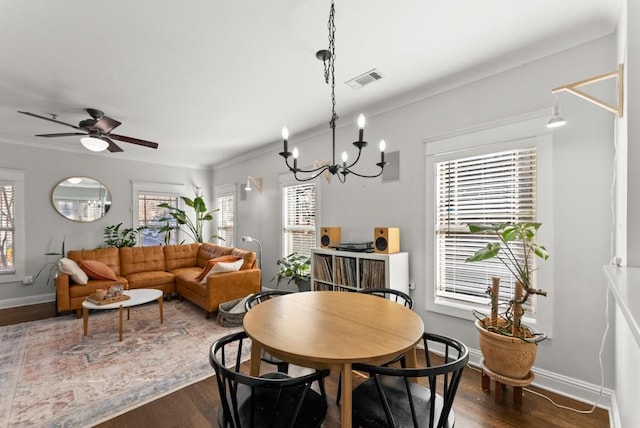 dining room with dark wood-style flooring, visible vents, and baseboards