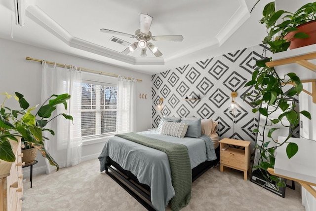 bedroom with light carpet, baseboards, visible vents, a raised ceiling, and an accent wall