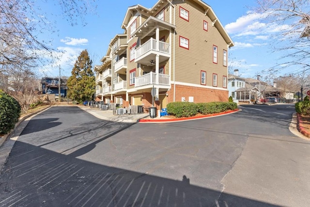 view of building exterior with a residential view and central AC