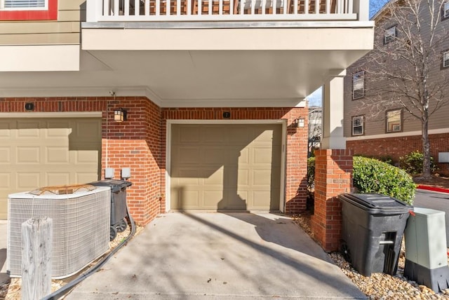 garage featuring central air condition unit and concrete driveway