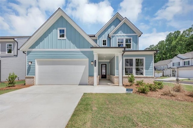 212 Birchwood Row, Canton, GA 30115 - view of front of property with board and batten siding, driveway, a front lawn, and brick siding