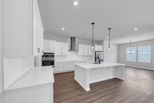 212 Birchwood Row, Canton, GA 30115 - kitchen with wall chimney range hood, backsplash, stainless steel appliances, white cabinets, and dark wood-style flooring