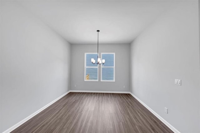 212 Birchwood Row, Canton, GA 30115 - empty room with a chandelier, dark wood finished floors, and baseboards